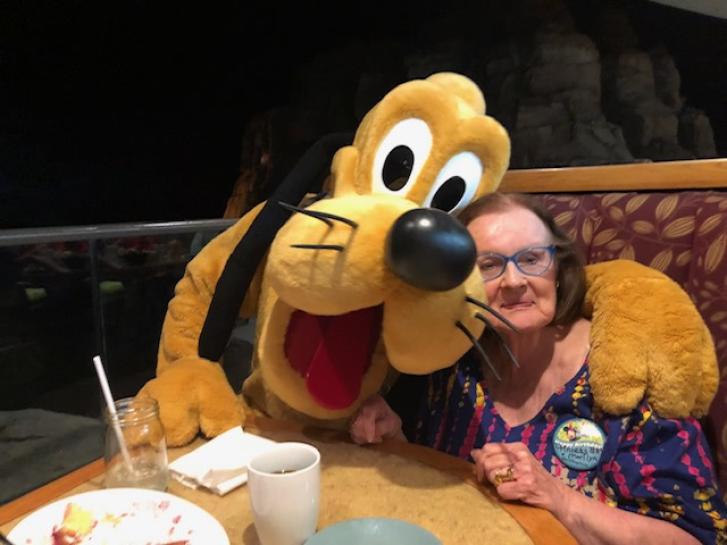 Guest Photo from Lorilee Alexandra Glenat: Guest with Pluto at Garden Grill at EPCOT