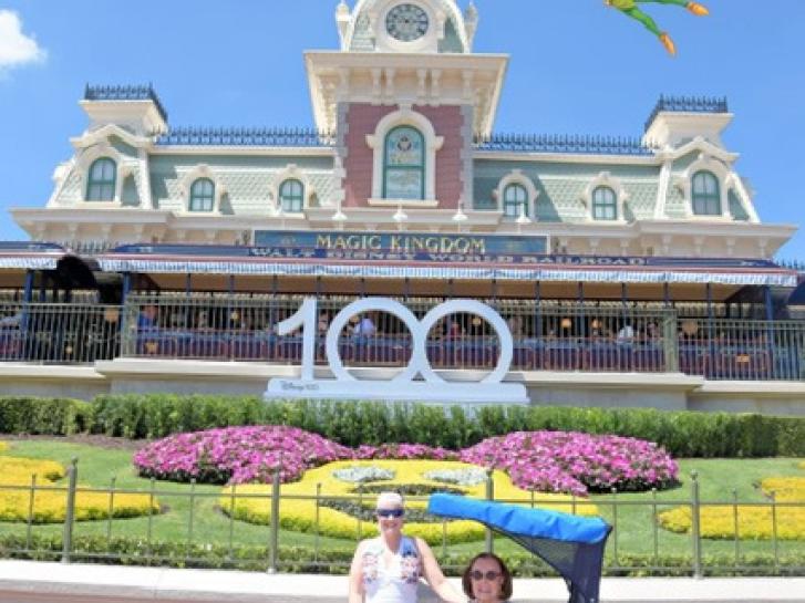 Guest Photo from Lorilee Alexandra Glenat: Guests in front of Mickey Mouse garden display at Magic Kingdom